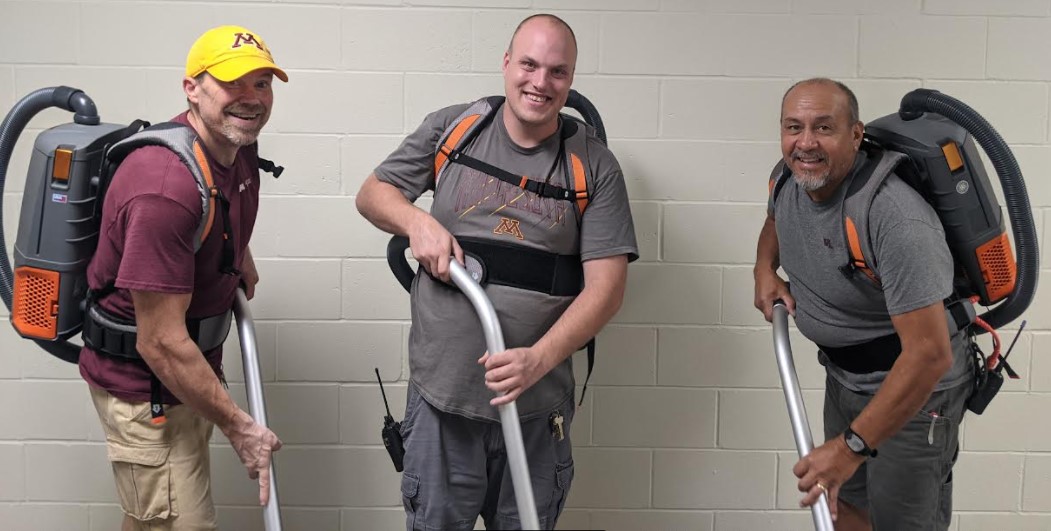 Rec Ctr Staff wearing new Hoover back pack vacs