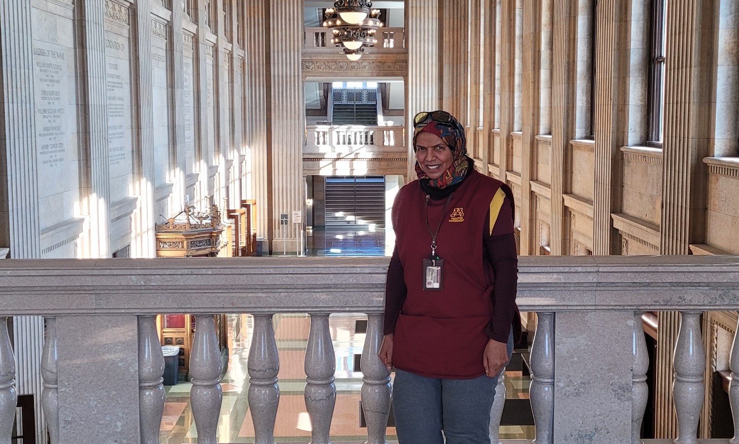 Fatma standing on 2nd floor overlooking the main entry lobby area